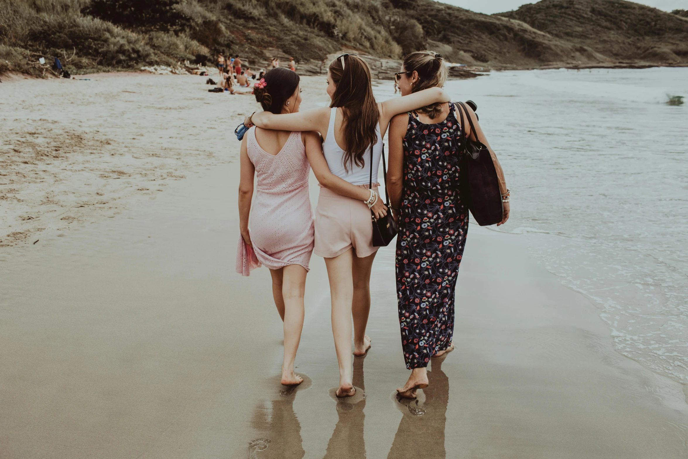 a group of women walking on top of a sandy beach, pexels contest winner, arm around her neck, college girls, three women, sleek legs