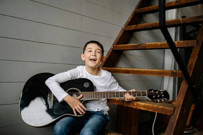 a little boy that is sitting down with a guitar, pexels contest winner, happening, laughing bear musician, teen boy, thumbnail, ready to model