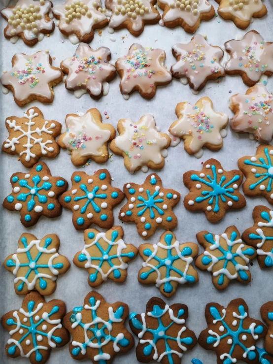 a tray full of cookies with frosting and sprinkles, by Lale Westvind, reddit, snowflakes, 🦑 design, no cropping, thumbnail