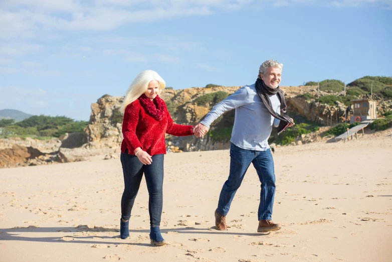 a man and a woman holding hands on a beach, white haired lady, flying towards the camera, profile image, wearing festive clothing