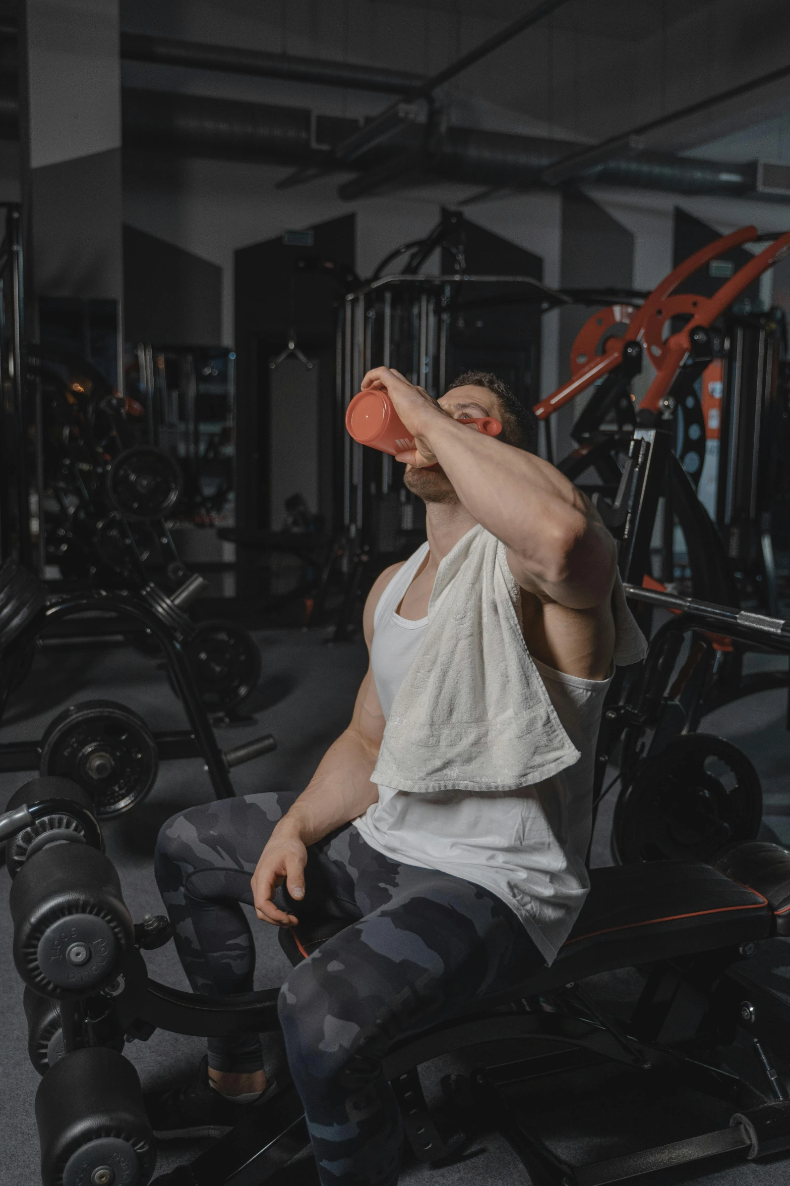 a man is drinking from a cup in a gym, by Adam Marczyński, pexels contest winner, renaissance, gif, half body photo, pixelated, dasha taran