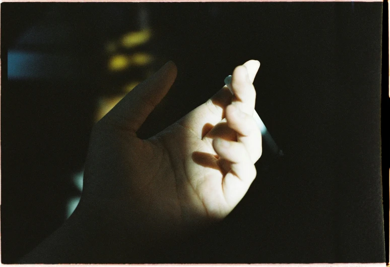 a person holding a cell phone in their hand, inspired by Elsa Bleda, autochrome photograph, glowing fingers, ignant, shot with hasselblad