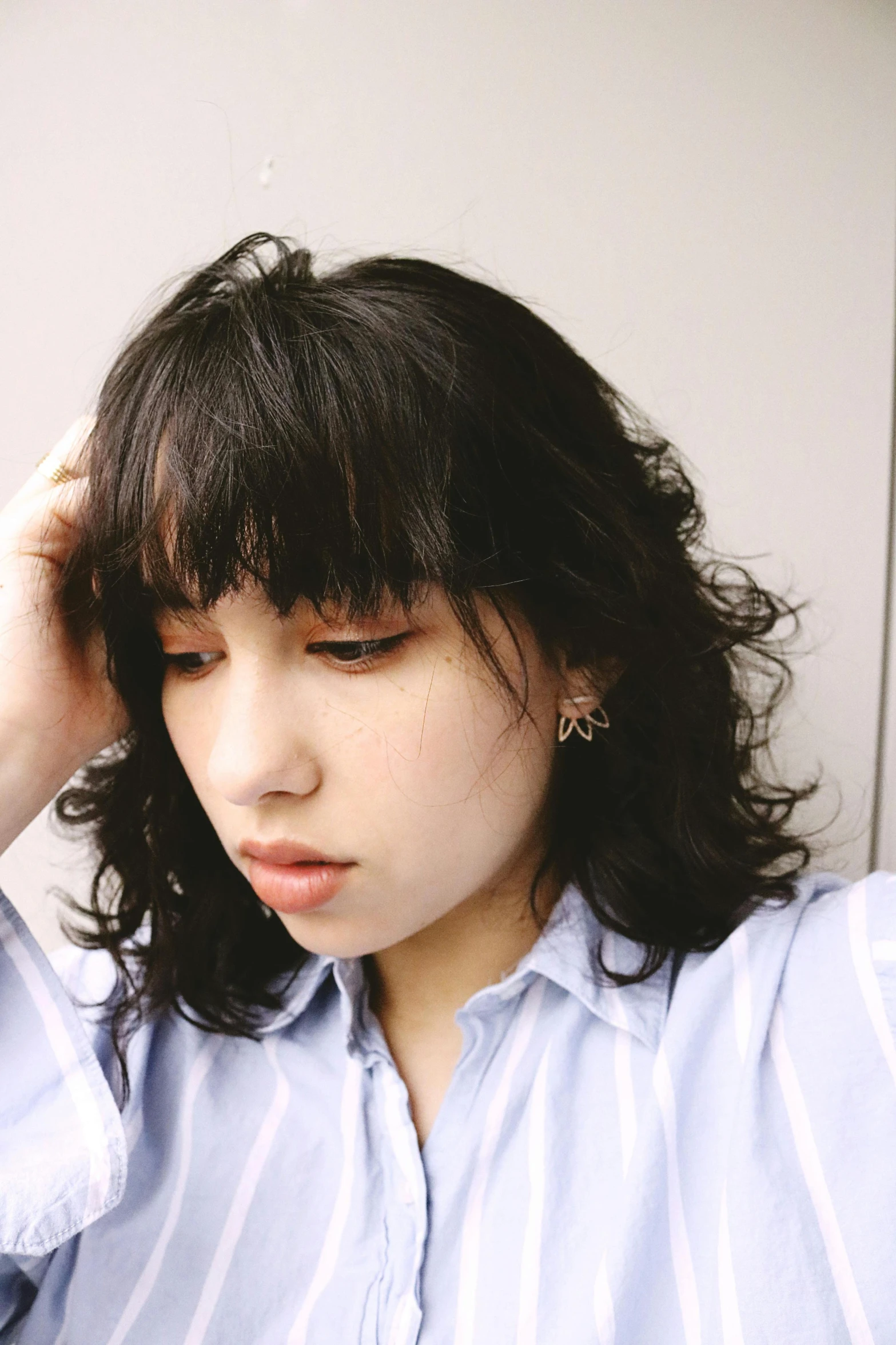 a woman holding a cell phone to her ear, an album cover, by Miyamoto, trending on reddit, curly bangs, 🤤 girl portrait, headshot profile picture, heartbroken