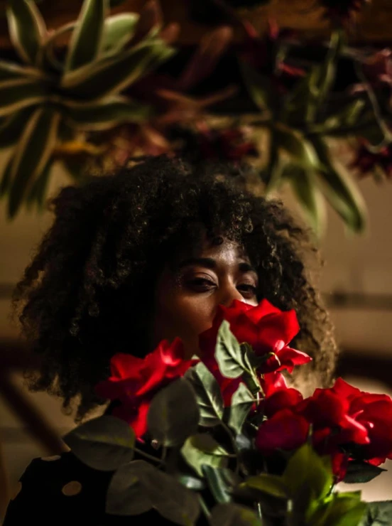 a woman holding a bouquet of red roses, inspired by Elsa Bleda, with afro, close to night, slide show, unedited