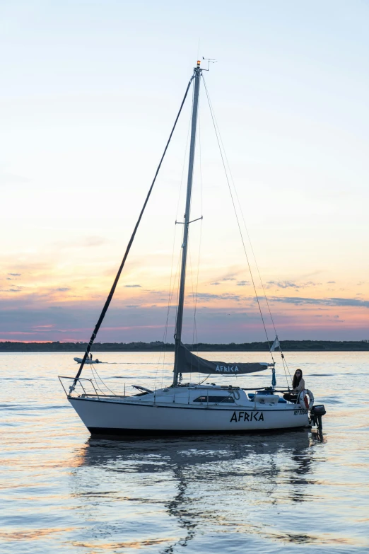 a sailboat floating on top of a body of water, happening, at twilight, 2 2 years old, the argo, poised