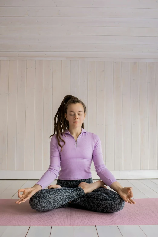 a woman sitting in a lotus position on a yoga mat, a portrait, by Nina Hamnett, trending on pexels, renaissance, dread, low quality photo, scandinavian, alex gray