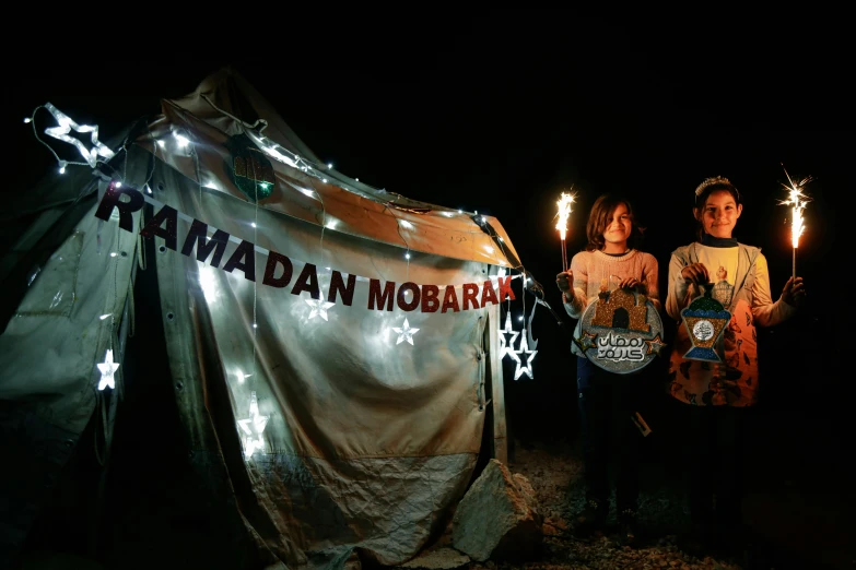 a group of people standing in front of a tent, an album cover, by Ibrahim Kodra, moon and candle, jordan, 2022 photograph, protesters holding placards