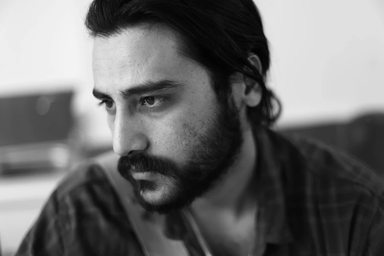 a black and white photo of a man with a beard, reddit, hurufiyya, actor, nekro petros afshar, davide sorrenti, photo still of behind view