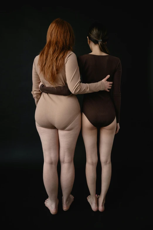 a couple of women standing next to each other, inspired by Vanessa Beecroft, unsplash, renaissance, patricia piccinini, thighs, ultra realistic photo, muted colored bodysuit