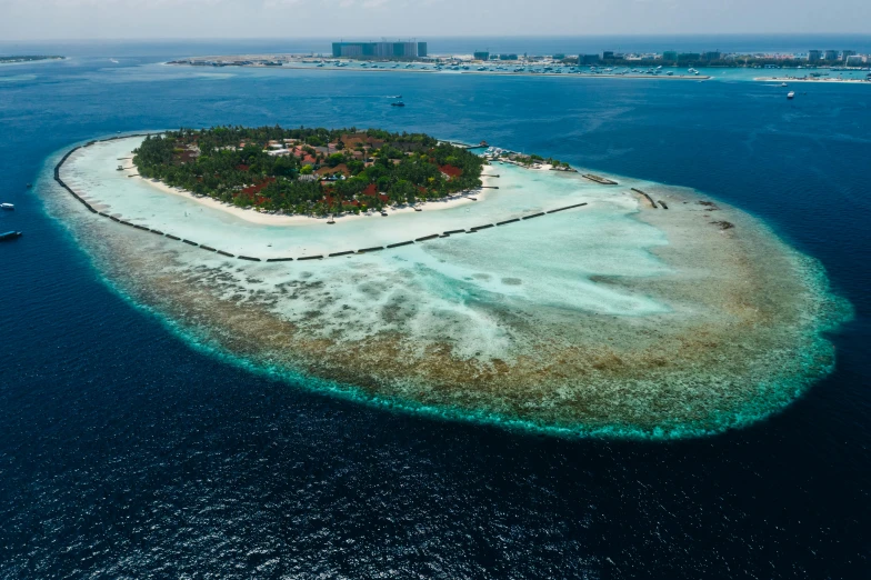 a small island in the middle of the ocean, by Matthias Stom, pexels contest winner, hurufiyya, resort, wide high angle view, thumbnail, maldives in background