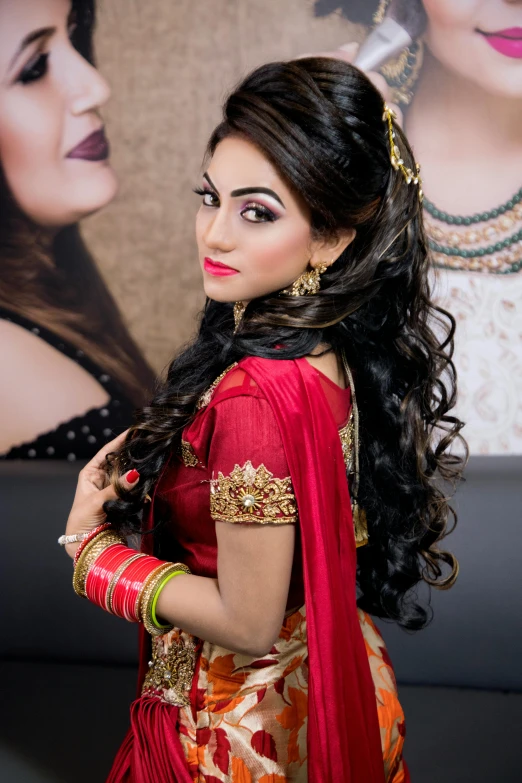 a woman in a red and gold sari, styled hair, backdrop, uploaded, half image