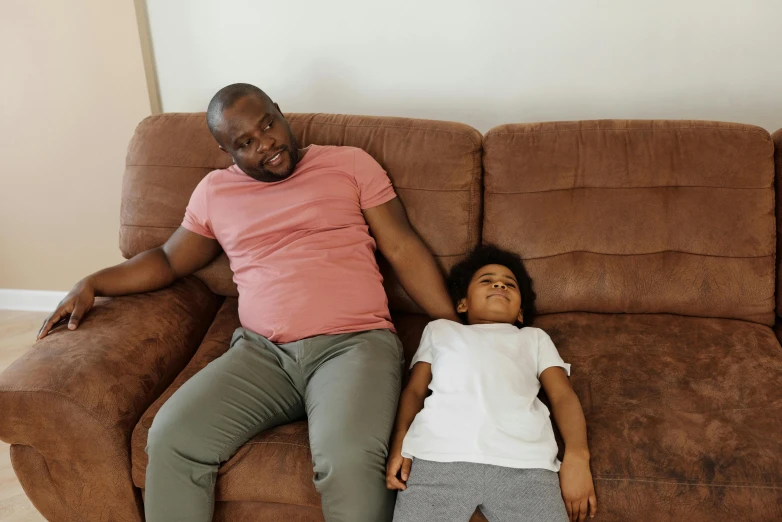 a man and a little girl laying on a couch, pexels contest winner, hurufiyya, ( brown skin ), bowater charlie and brom gerald, absent father, 15081959 21121991 01012000 4k