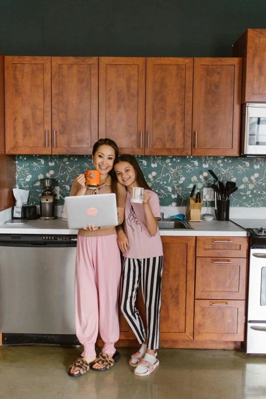 a couple of women standing next to each other in a kitchen, inspired by helen huang, pexels contest winner, in front of a computer, juice, isabela moner, japanese collection product