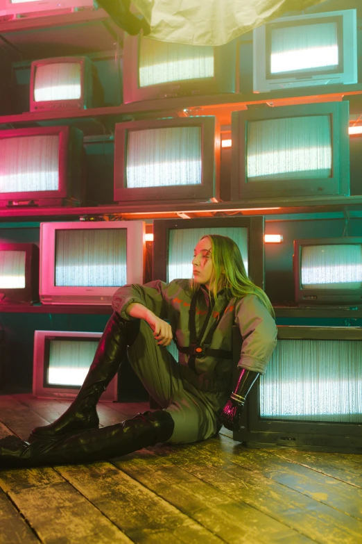 a woman sitting on the floor in front of a wall of televisions, inspired by David LaChapelle, saoirse ronan, wearing space techwear, green crt monitors, portrait of crazy post malone