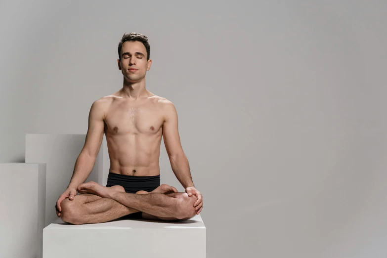 a man sitting in the middle of a yoga pose, figuration libre, lean man with light tan skin, promo image, high quality upload, front facing