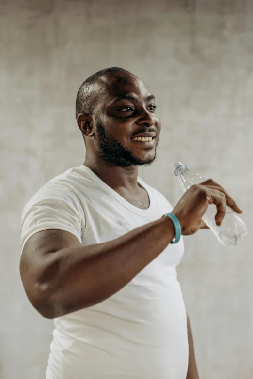 a man in a white shirt holding a bottle of water, afro tech, performance, wearing bionic implants, promo image