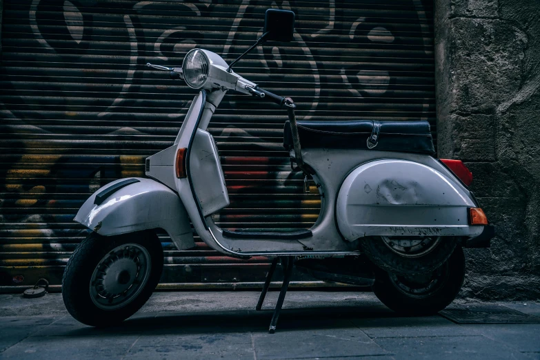 a motor scooter parked in front of a garage door, pexels contest winner, thumbnail, white steel, italian, leaked