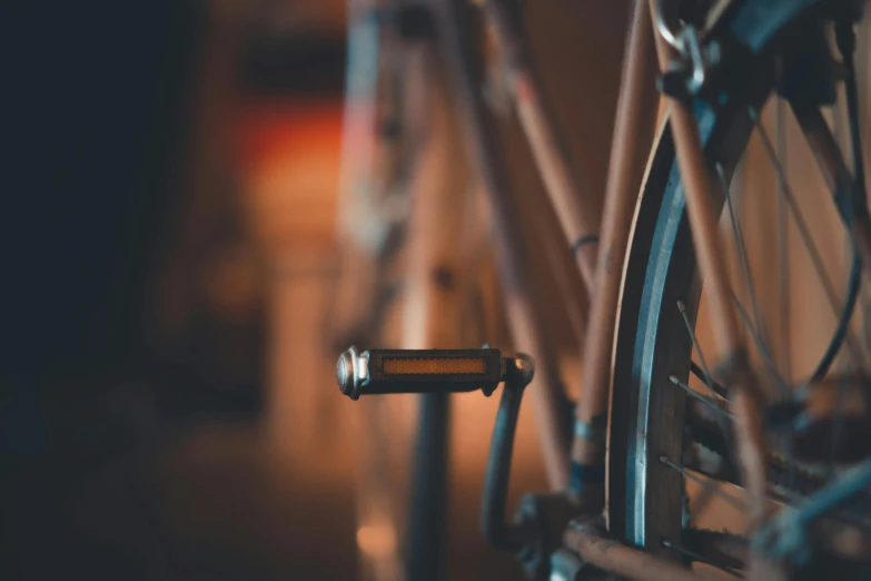 a close up of the front wheel of a bicycle, pexels contest winner, realism, warm moody lighting, a photograph of a rusty, 🚿🗝📝, lo-fi