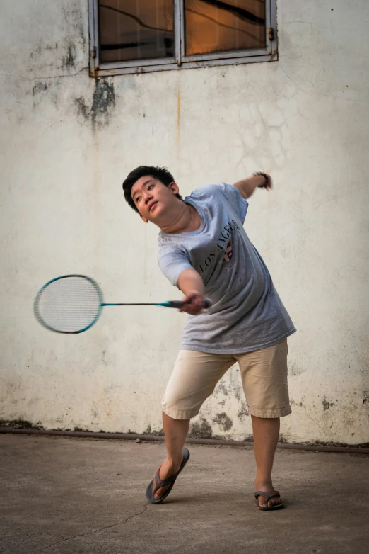 a man hitting a tennis ball with a racquet, an album cover, inspired by Fei Danxu, pexels contest winner, happening, rhinoceros playing badminton, street life, julian ope, battered