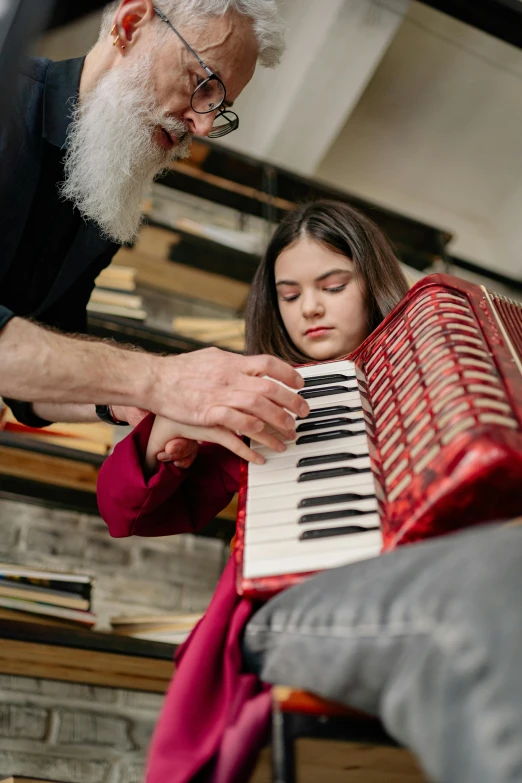 an older man playing an accordion with a young girl, by Julia Pishtar, pexels contest winner, renaissance, studio quality, people at work, square, courtesy of centre pompidou