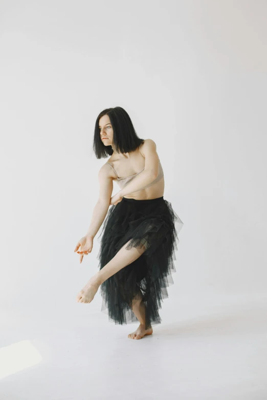 a woman in a tutu posing for a picture, an album cover, inspired by Fei Danxu, unsplash, rick owens, ignant, long thin black hair, julian ope