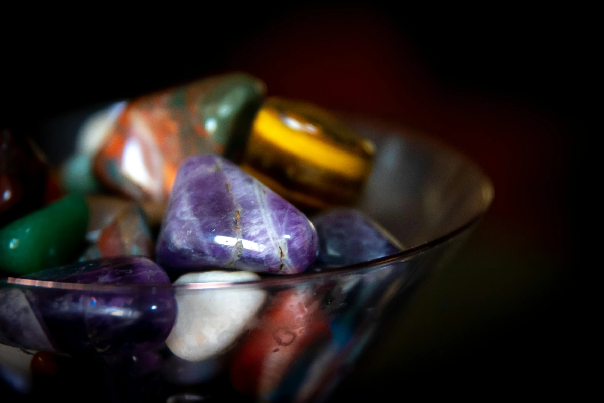 a glass bowl filled with different colored rocks, a portrait, pexels, gold and purple, shot on sony a 7, premium, onyx