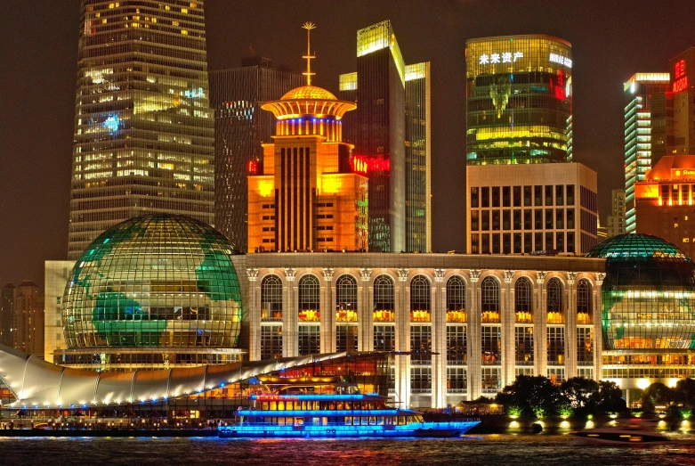 a view of a city at night from across the water, chinese building, central hub, neon city domes, photo taken from a boat