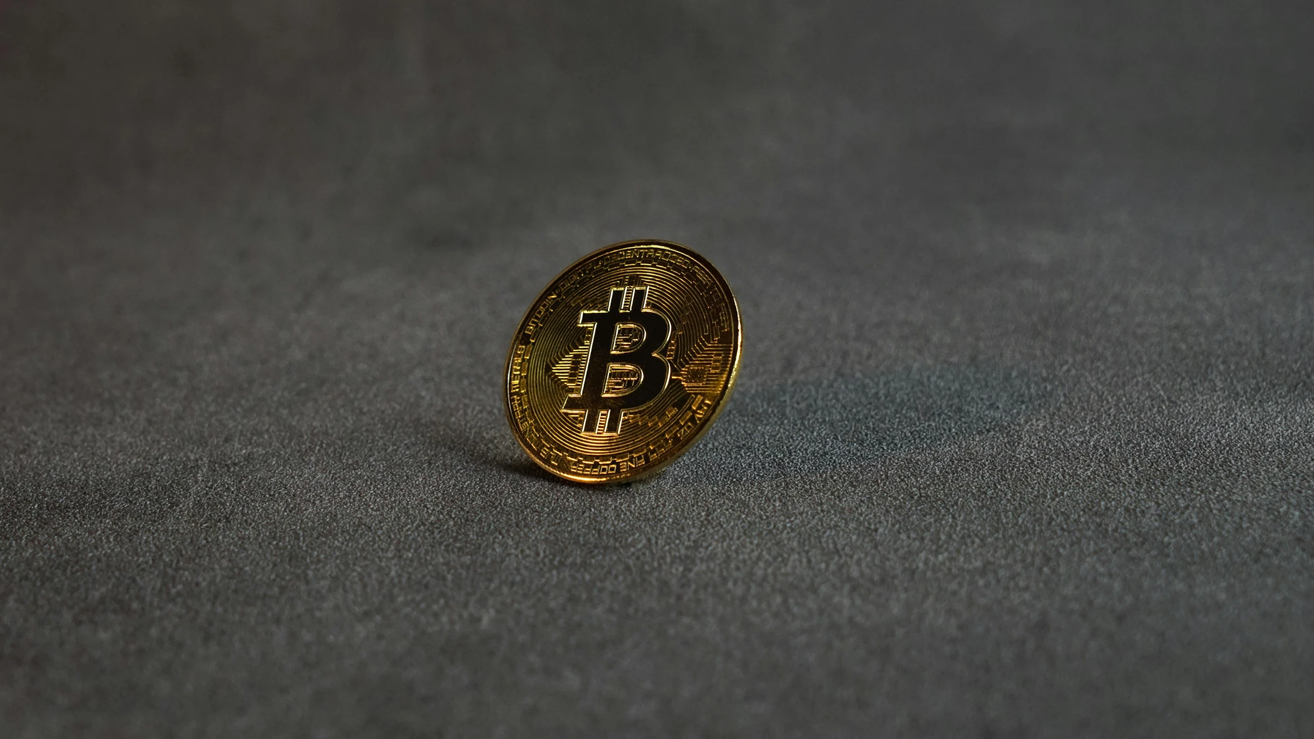 a bit coin sitting on top of a table, walking towards the camera, product image, one black, small