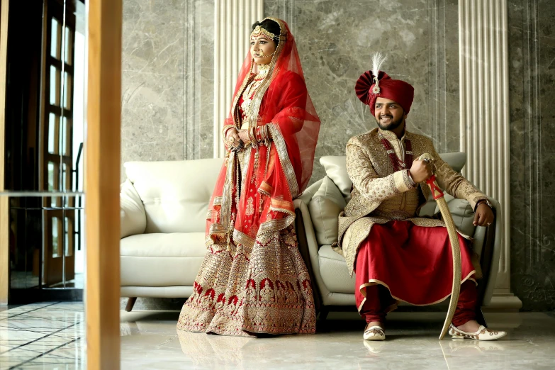 a man and a woman sitting next to each other, luxurious wedding, wearing red attire, tv still, profile image