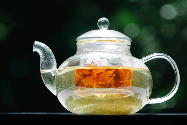 a glass tea pot filled with green tea, inspired by Ma Yuan, pexels, square, white and orange, al fresco, lotus