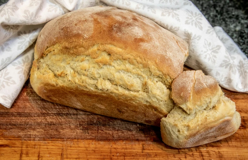 a loaf of bread sitting on top of a wooden cutting board, thumbnail, listing image