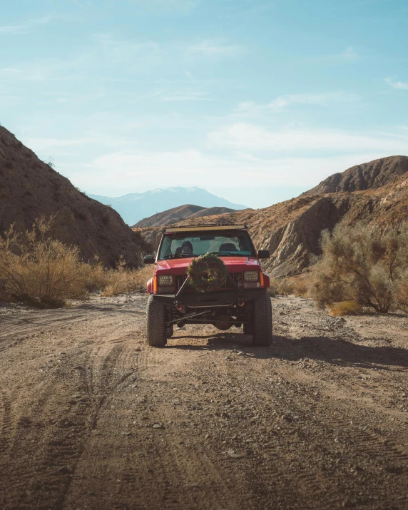 a red jeep driving down a dirt road, by Kyle Lambert, pexels contest winner, renaissance, palm springs, wide full body, 80s photo, instagram story