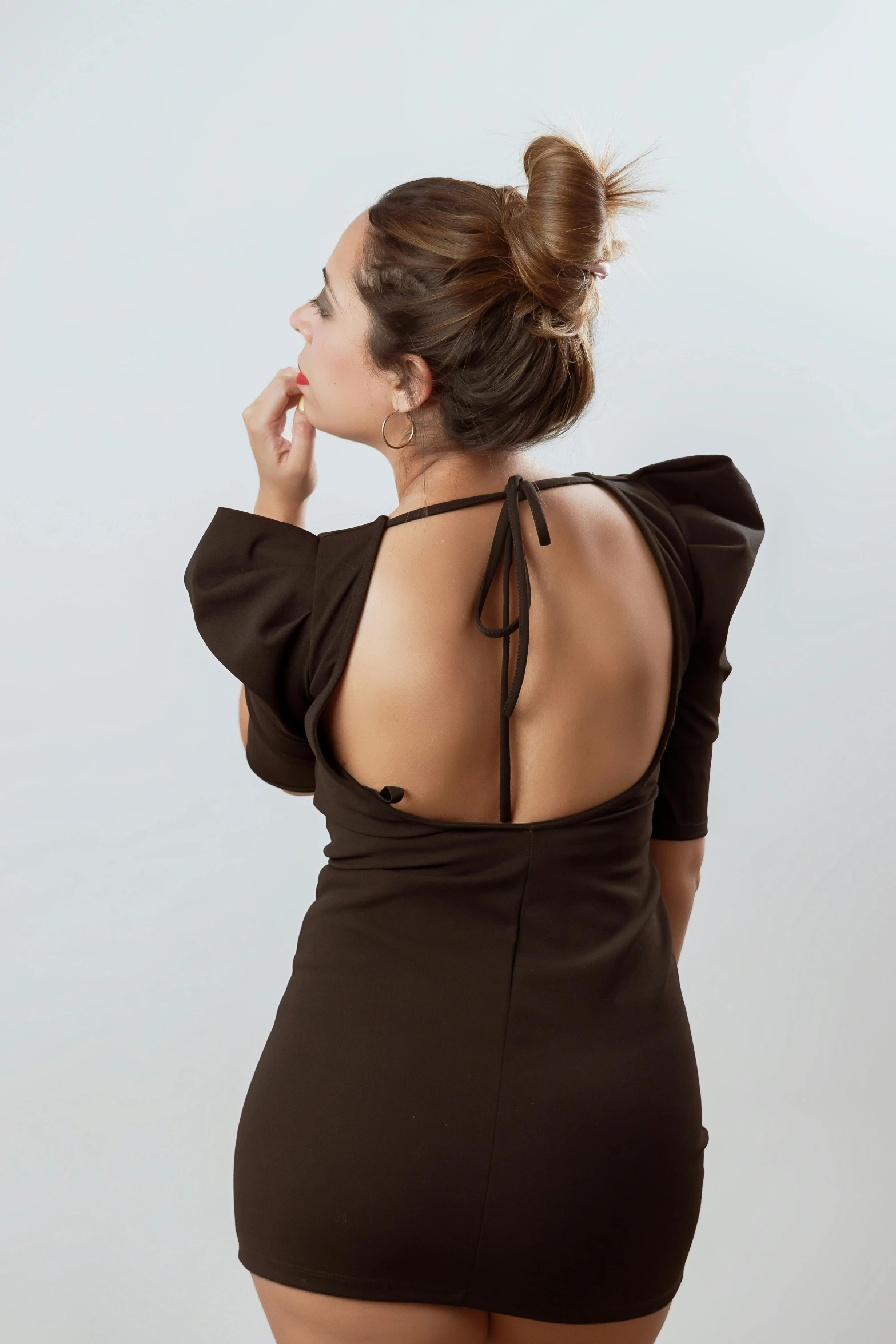 the back of a woman in a black dress, inspired by Oswaldo Viteri, wearing a brown, puff sleeves, open back dress, profile image