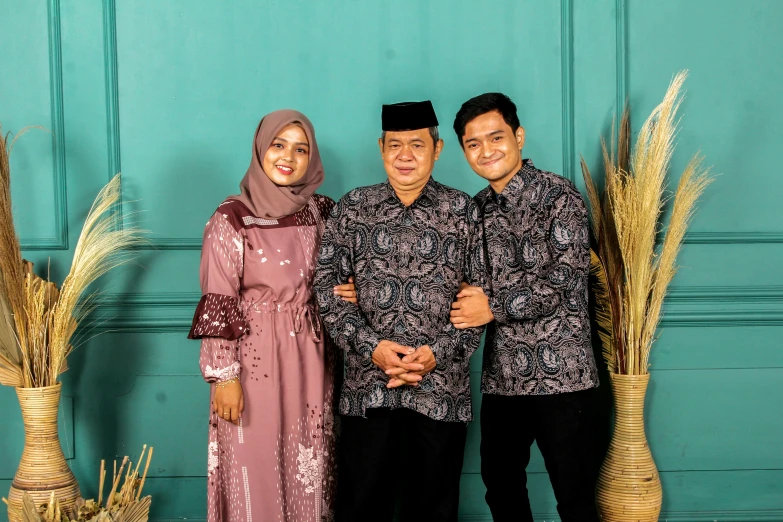 a man and a woman standing next to each other, a picture, by Basuki Abdullah, instagram, hurufiyya, portrait of family of three, background image, square, decorative