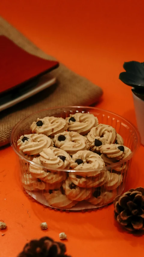 a bowl of cookies sitting on top of a table, by Cafer Bater, hurufiyya, pinecone, celebration of coffee products, thumbnail, kuntilanak