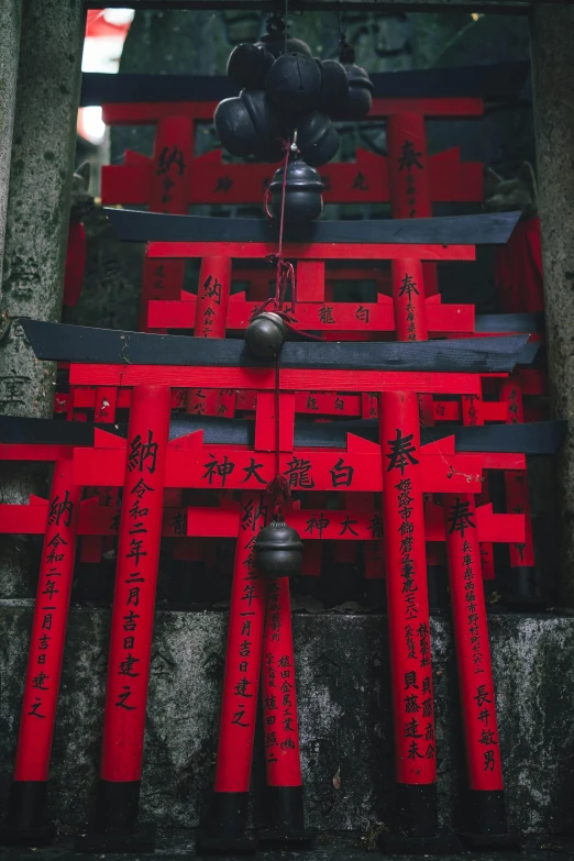 a group of red tori tori tori tori tori tori tori tori tori tori tori tori tori tori, inspired by Torii Kiyomoto, pexels contest winner, black steel with red trim, red fluid on walls of the church, bells, kanji markings