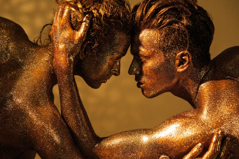 a bronze statue of two women kissing each other, an album cover, by Lee Gatch, trending on pexels, figurative art, gold bodypaint, sunburn, lesbian, lee madgwick & liam wong