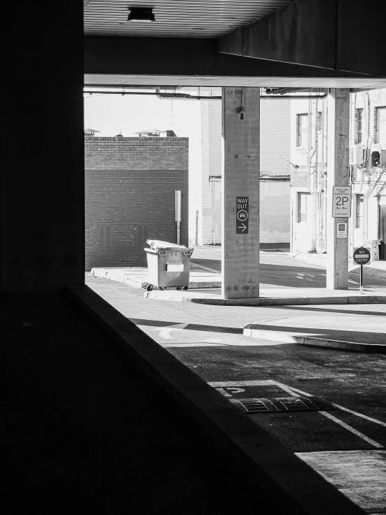 a black and white photo of an empty parking garage, inspired by Vivian Maier, unsplash, cyberpunk back alley, square, morning sunlight, world seen only through a portal