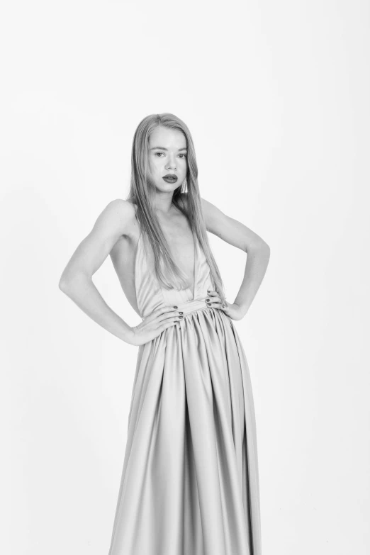 a black and white photo of a woman in a dress, portrait of kim petras, 'white background'!!!, studio medium format photograph, female figure in maxi dress