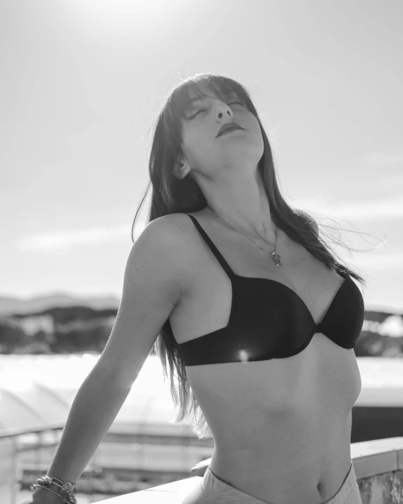 a black and white photo of a woman in a bikini, a black and white photo, pexels contest winner, straight bangs, sunny sky, girlboss, cannes