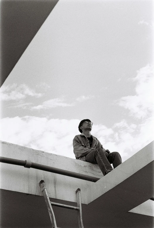 a man sitting on top of a roof next to a ladder, inspired by Sergio Larraín, unsplash, brutalism, ((portrait)), 1990s photograph, skies, jean giraud portrait