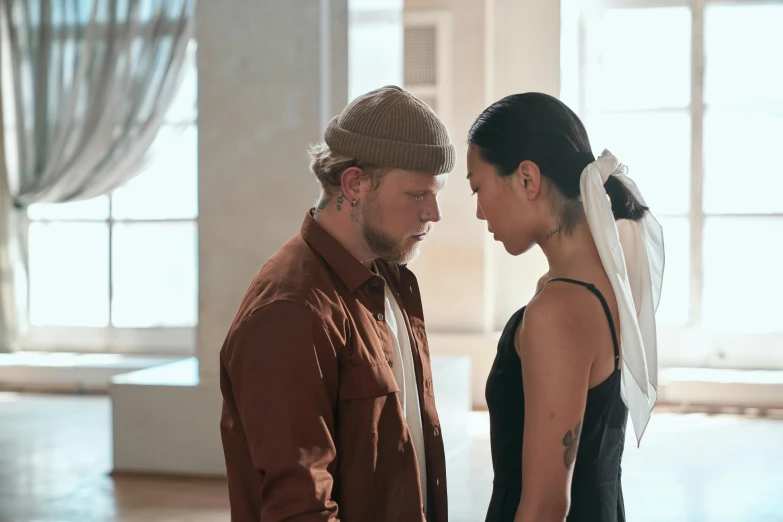 a man and a woman standing next to each other, a tattoo, trending on pexels, visual art, wearing a chocker and cute hat, dance scene, demna gvasalia, [ theatrical ]