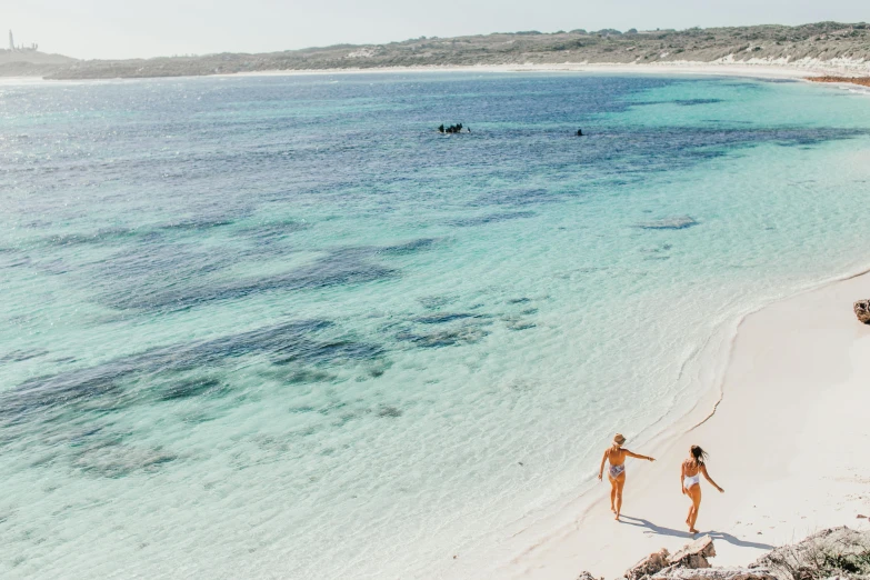 a couple of people walking on top of a sandy beach, reefs, flatlay, lisa brawn, tans