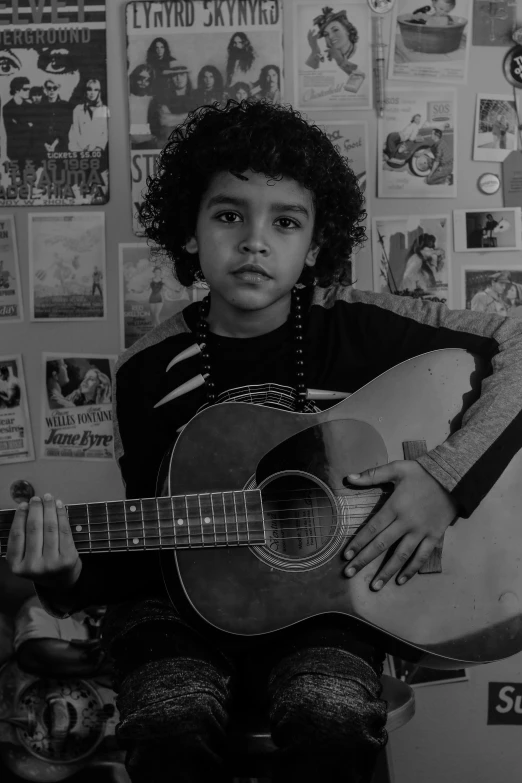 a black and white photo of a boy with a guitar, an album cover, pexels contest winner, mixed race, & her expression is solemn, parental advisory, enes dirig