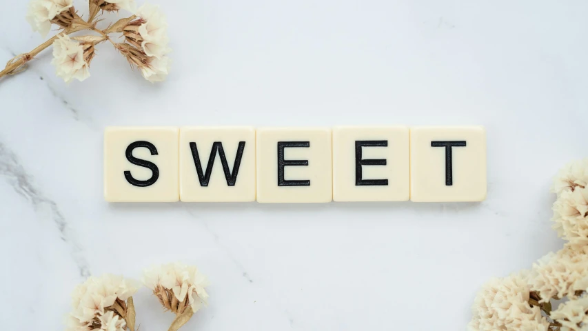 the word sweet spelled in scrabbles on a marble surface, trending on pexels, background image, profile picture, sugary sweet, skincare