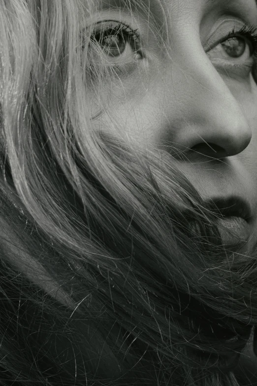 a black and white photo of a woman with long hair, by artist, trending on pexels, hyperrealism, close - up profile face, extremely pale blond hair, movie still of a tired, high angle closeup portrait