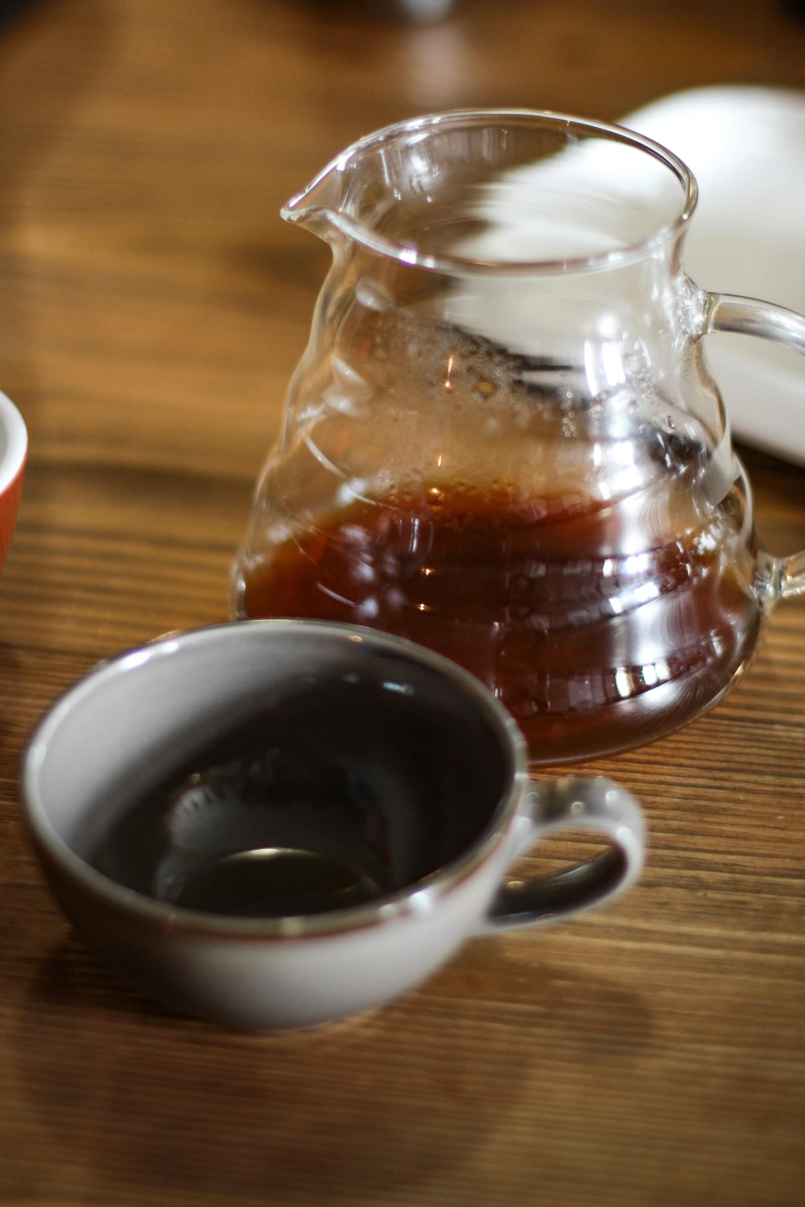 a coffee pot sitting on top of a wooden table, two cups of coffee, thumbnail, up close, sauce