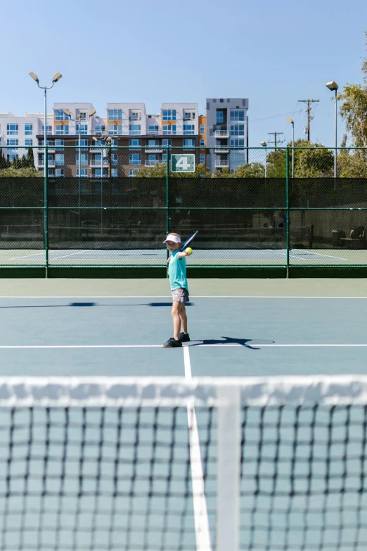 a person standing on a tennis court holding a racquet, little kid, oceanside, jen atkin, apartments