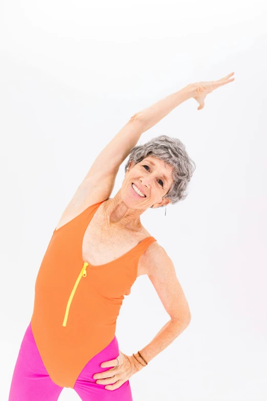 a woman doing a yoga pose against a white background, by Betty Churcher, arabesque, silver hair (ponytail), sam shearon, orange body, she is about 7 0 years old