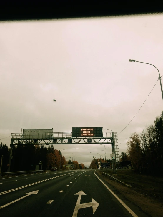 a view of a highway through a car window, an album cover, inspired by Elsa Bleda, unsplash, graffiti, helsinki, trending on vsco, autumn season, overcast skies